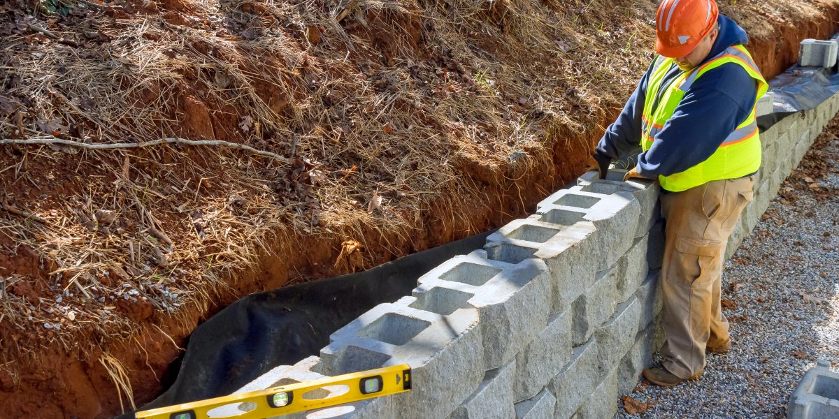 retaining walls | construction worker is using cement blocks for bui 2023 11 27 05 31 22 utc